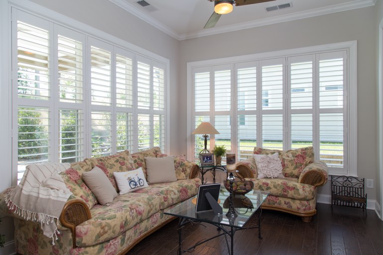 Many different interior styles work with faux wood plantation shutters in Hartford. Sunroom with interior shutters in Hartford.